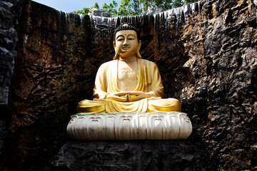 Beautiful amitabha buddha statue in garden for thai people travel visit respect praying in gardening fountain waterfalls of Wat Laksi Rat Samosorn temple at Ban Phaeo city in Samut Sakhon, Thailand