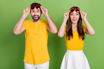 Wall Mural - Photo of two crazy shocked people hands touch sunglass unbelievable isolated on yellow color background