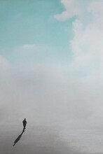 Lonely Man Walks Towards The Horizon Of A Surreal Sky
