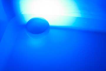 Wall Mural - Abstract blurry image of a crystal ball in blue. Lens ball in blur.