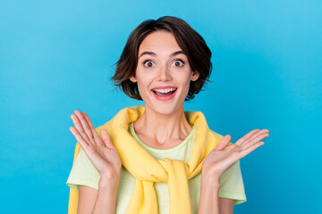 Poster - Photo of impressed millennial brunette lady wear green t-shirt jumper isolated on blue color background