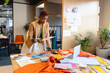 © Wavebreak Media - African american female fashion designer analyzing document at desk in studio