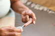© Wavebreak Media - Cropped hands of african american senior woman examining sugar with glucometer on sofa at home