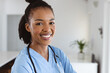 © Wavebreak Media - Portrait of smiling african american young female doctor with stethoscope around neck at home