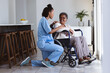 © Wavebreak Media - African american female doctor talking with smiling senior patient sitting on wheelchair at home