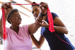 © Wavebreak Media - African american female physiotherapist assisting senior woman in exercising with resistance band