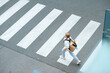 © Alliance - girl crossing crosswalk and going to school outdoors in city