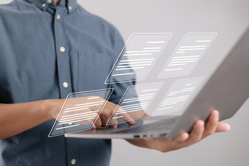 Aufkleber - A businessman works on a laptop with electronic document icons, E-document management, and an online database.