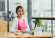 © PaeGAG - Portrait of smiling beautiful Asian business woman enjoy the idea sitting at office, Asian student girl look at laptop while doing homework making video call abroad using internet friend connection.