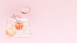 Pink wine. Holiday, food banner with a jar of salmon red caviar, tartlets, rose wine on a pink tray on a pink background with copy space. Appetizer with sea delicacies. Gourmet sea food with wine