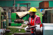 © NVB Stocker - Black Male Engineer Working on machine in Factory. black man engineer checking Quality control the machine. Service and Maintenance of factory machinery. American African people.