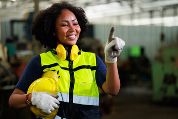Wall Mural - Portrait african american female engineer worker wearing safety hard hat helmet. Metal lathe industrial manufacturing factory