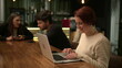 © Marco - One happy millennial woman using laptop computer at cafe smiling browsing receiving positive notification