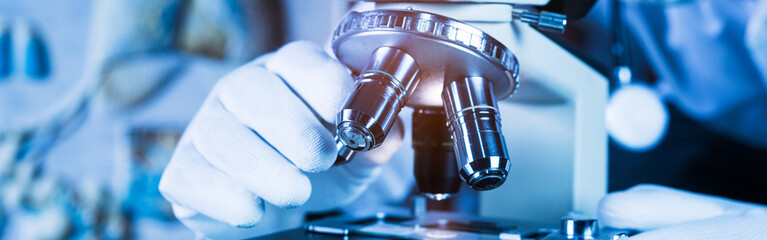 Close-up of a metal lens microscope at the lab.