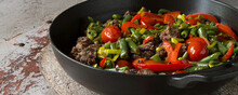 Pan With Venison With Green Beans And Bell Peppers On A Light Table