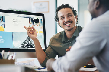 Wall Mural - Can you see what Im referring to. Shot of two young businessmen having a discussion in an office.