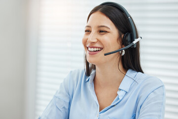 Fototapete - Let me know how I can help you. Shot of an attractive young saleswoman sitting alone in her office and wearing a headset.