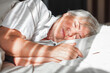 Senior  woman sleeping on bed in bedroom