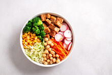 Vegan Buddha Bowl With Tofu, Colorful Vegetables On Base Of Brown Rice.