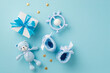 Baby accessories concept. Top view photo of giftbox knitted booties teddy-bear toy teether and gold stars on isolated pastel blue background