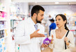 © JackF - Pharmacist advises customer in a pharmacy, offers medicine for body care