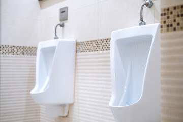 Men public toilet,Closeup moder white urinals in men's bathroom, design of white ceramic urinals for men,