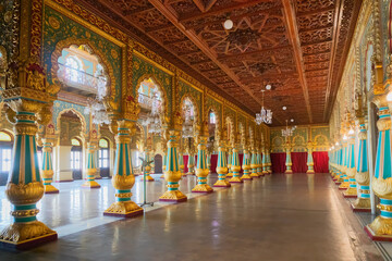 Wall Mural - Mysore, Karnataka, India - November 25th 2018 : Beautiful decoated interior ceiling and pillars of the Ambavilasa Hall, inside the royal Mysore Palace. Gold used on gilded columns and glass ceiling.