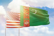 Sunny blue sky and flags of turkmenistan and usa