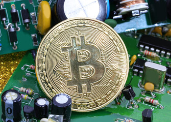 coins with the symbol B in capital letters symbolizing the cryptocurrency called BITCOIN above the electronic devices