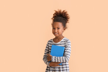 Poster - Little African-American girl with book on beige background