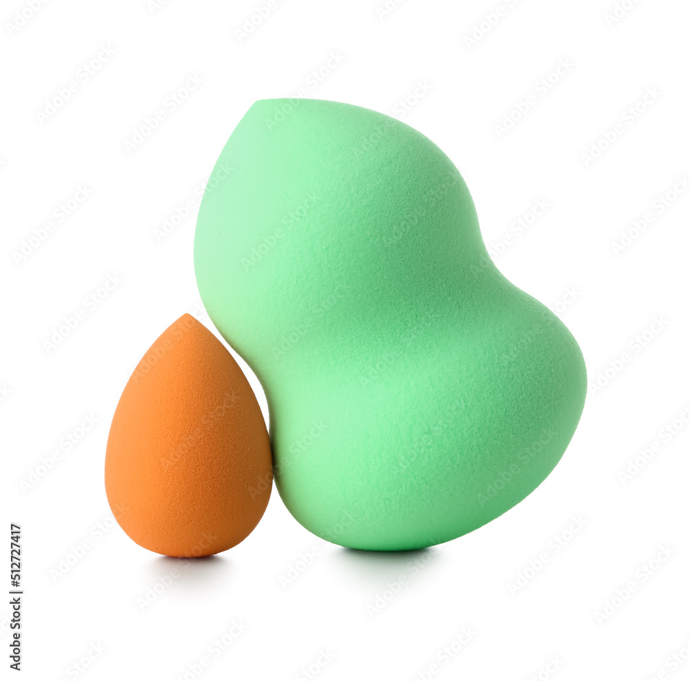 Different make up sponges on white background
