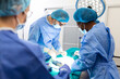 © Graphicroyalty - Surgeon team in uniform performs an operation on a patient at a cardiac surgery clinic. Modern medicine, a professional team of surgeons, health.