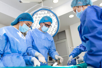 Wall Mural - Surgeon team in uniform performs an operation on a patient at a cardiac surgery clinic. Modern medicine, a professional team of surgeons, health.