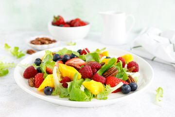 Sticker - Fruit and berry salad with strawberry, blueberry, raspberry, mango and pecan nuts. Healthy food, diet