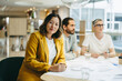 © Jacob Lund - Ethnic businesswoman sitting in a meeting with her colleagues