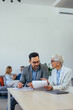 © bnenin - Focused man and woman, doing a paperwork, holding some papers.