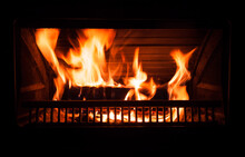 Fire Burns In A Fireplace At Night