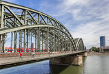 Fototapeta Mosty linowy / wiszący - Historic steel bridge over the river Rhine in Cologne, Germany