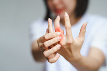 Woman Has Finger Joint Pain Due To Rheumatoid Arthritis. Health Care Concept.