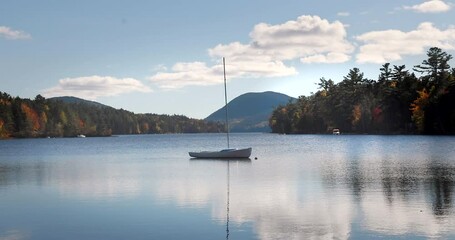 Wall Mural - Small sailboat on the Long Pond in the Acadia National Park, Maine. Concept of tranquility and travel