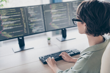 Back view photo of cool intelligent student girl system administrator practicing improving system optimize security
