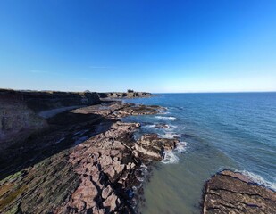 Canvas Print - Aerial view of the sea and rocky coastline on the East coast of Scotland. 