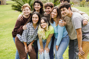 Young group of friends having fun outdoor with university on background - Main focus on curvy girl face