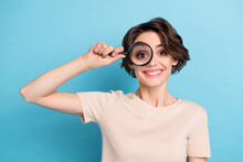 Photo Of Adorable Cheerful Young Woman Visit Oculist Check Her Eye Vision With Magnifier Isolated On Blue Color Background