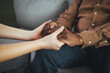 © Dragana Gordic - Closeup shot of a young woman holding a senior man's hands in comfort. Cropped shot of a senior man and a nurse holding hands. Not just a caregiver but a confidant