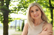 © New Africa - Portrait of beautiful woman outdoors on sunny day, space for text