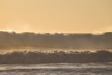Fototapeta Niebo - Ocean waves in the sunset