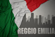 abstract silhouette of the city with text Reggio Emilia near waving national flag of italy on a gray background.