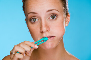 Wall Mural - Woman brushing her teeth