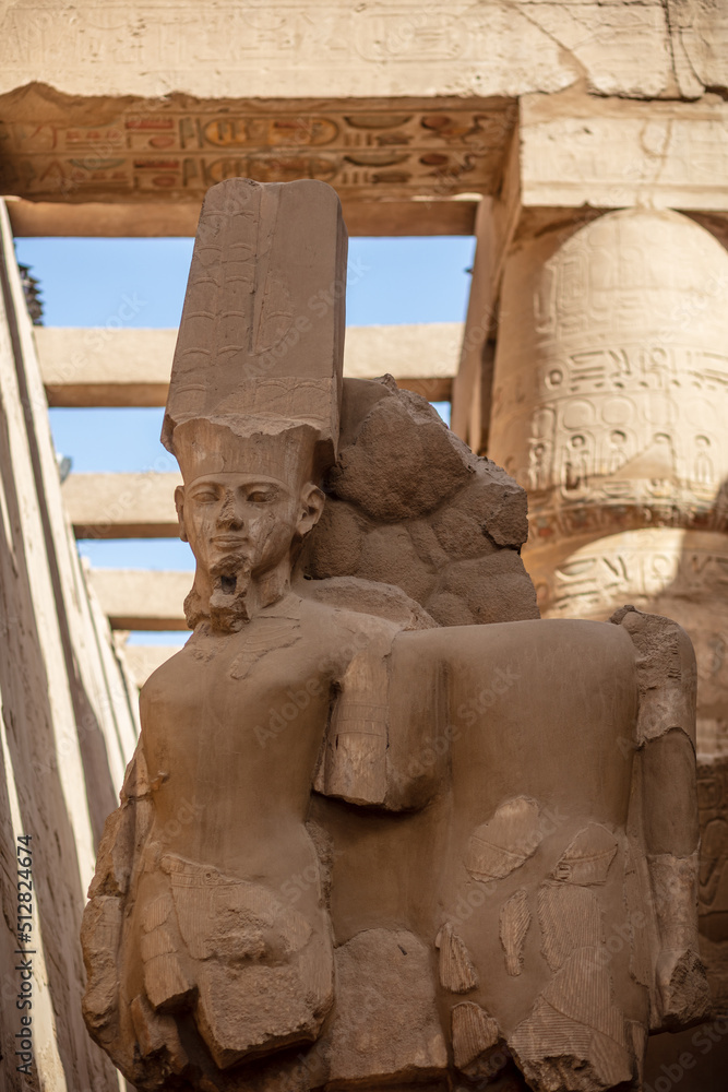 Statues of ancient Egyptian pharaohs and gods. Various hieroglyphs on ...